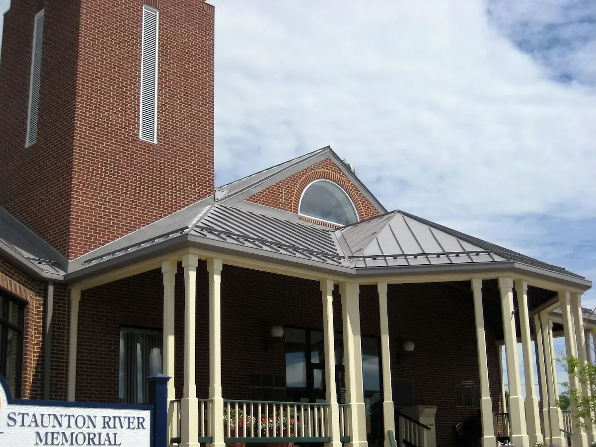 Skilled roofing craftsmen working on a residential roof in Loretto